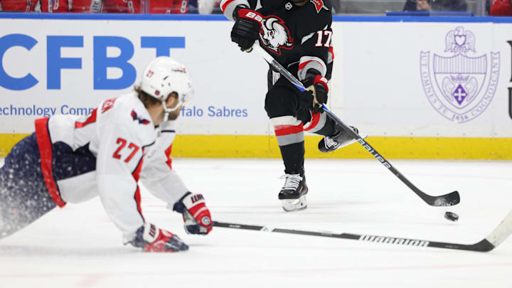 Mar 12, 2026; Buffalo, New York, USA;  Washington Capitals defenseman Timothy Liljegren (27) tries to block a shot by Buffalo Sabres left wing Jason Zucker (17)  Mandatory Credit: Timothy T. Ludwig-Imagn Images
