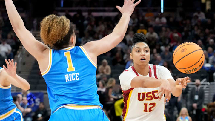 UCLA Bruins guard Kiki Rice (1) guards USC Trojans guard JuJu Watkins (12) as she passes the ball during the second half of the 2025 TIAA Big Ten Women's Basketball Tournament final game on Sunday, March 9, 2025, at Gainbridge Fieldhouse in Indianapolis. UCLA defeated USC 72-67.
