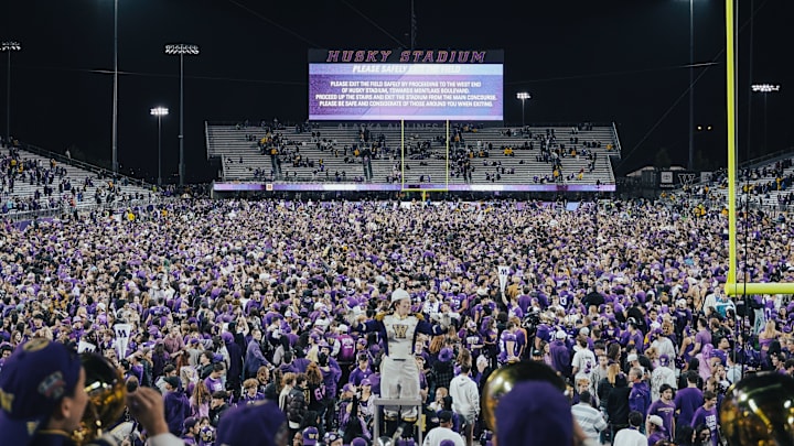 Husky fans fill the field after a 27-17 win over Michigan in 2024.