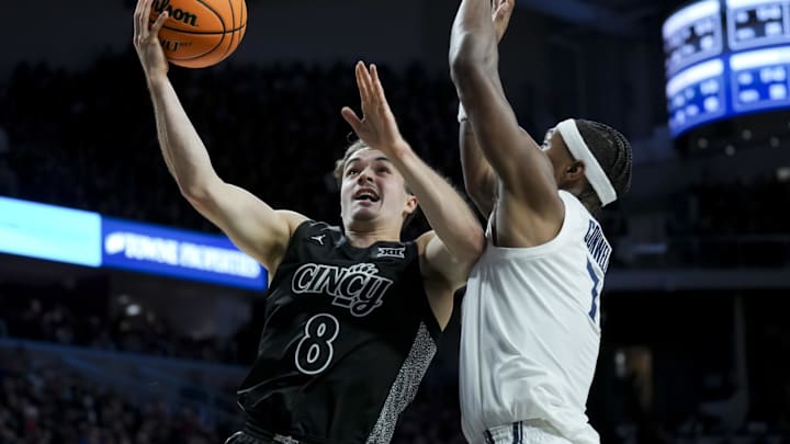 Dec 14, 2024; Cincinnati, Ohio, USA; Cincinnati Bearcats guard Connor Hickman (8) drives to the basket against Xavier Musketeers guard Ryan Conwell (7) in the second half at Fifth Third Arena. Mandatory Credit: Aaron Doster-Imagn Images Dec 14, 2024; Cincinnati, Ohio, USA; Cincinnati Bearcats guard Connor Hickman (8) drives to the basket against Xavier Musketeers guard Ryan Conwell (7) in the second half at Fifth Third Arena. Mandatory Credit: Aaron Doster-Imagn Images