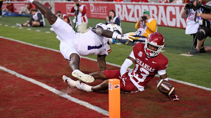 Oct 19, 2024; Fayetteville, Arkansas, USA; Arkansas Razorbacks defensive back Marquise Robinson (13) defends a pass intended for LSU Tigers wide receiver Aaron Anderson (1) during the first quarter at Donald W. Reynolds Razorback Stadium. Mandatory Credit: Nelson Chenault-Imagn Images