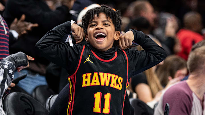 Jan 15, 2024; Atlanta, Georgia, USA; Fan celebrating Atlanta Hawks shot against San Antonio Spurs during the fourth quarter at State Farm Arena. Mandatory Credit: Jordan Godfree-Imagn Images