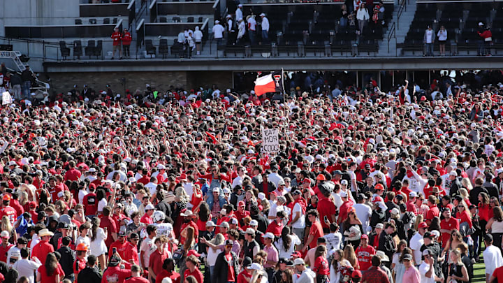 Nov 8, 2025; Lubbock, Texas, USA; Texas Tech Red Raiders fans fill the field after the game against the Brigham Young Cougars at Jones AT&T Stadium. Mandatory Credit: Michael C. Johnson-Imagn Images Nov 8, 2025; Lubbock, Texas, USA; Texas Tech Red Raiders fans fill the field after the game against the Brigham Young Cougars at Jones AT&T Stadium. Mandatory Credit: Michael C. Johnson-Imagn Images