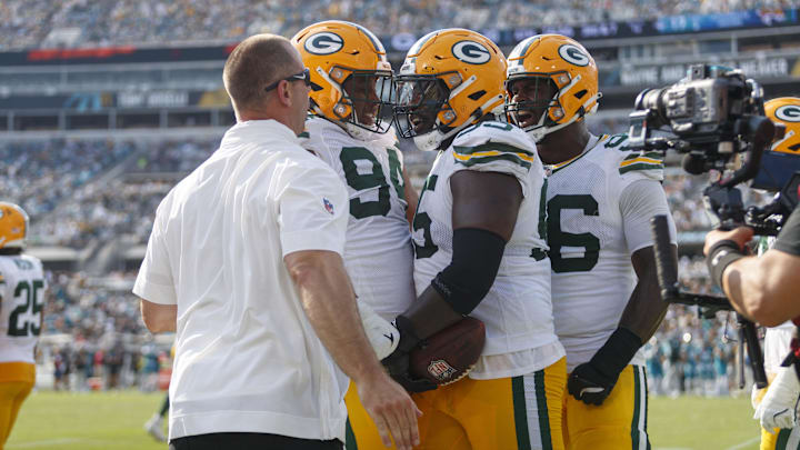 Oct 27, 2024; Jacksonville, Florida, USA; Green Bay Packers defensive lineman Devonte Wyatt (95), defensive lineman Karl Brooks (94), and defensive lineman Colby Wooden (96) celebrate a recovered fumble against the Jacksonville Jaguars during the third quarter at EverBank Stadium. Mandatory Credit: Morgan Tencza-Imagn Images