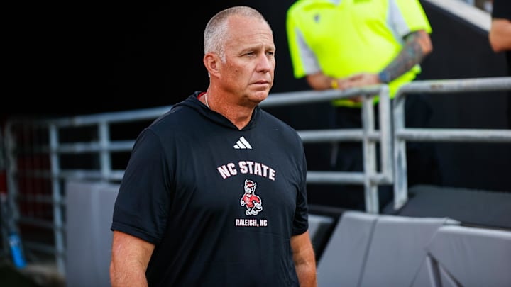 Aug 28, 2025; Raleigh, North Carolina, USA; North Carolina State Wolfpack head coach Dave Doeren walks out during the warmups prior to the game against East Carolina Pirates at Carter-Finley Stadium. Mandatory Credit: Jaylynn Nash-Imagn Images