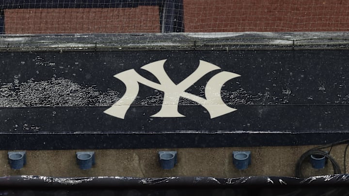 Aug 17, 2020; Bronx, New York, USA; A general view of rain falling on the  New York Yankees logo on the first base dugout roof during a rain delay in the game between the New York Yankees and the Boston Red Sox.