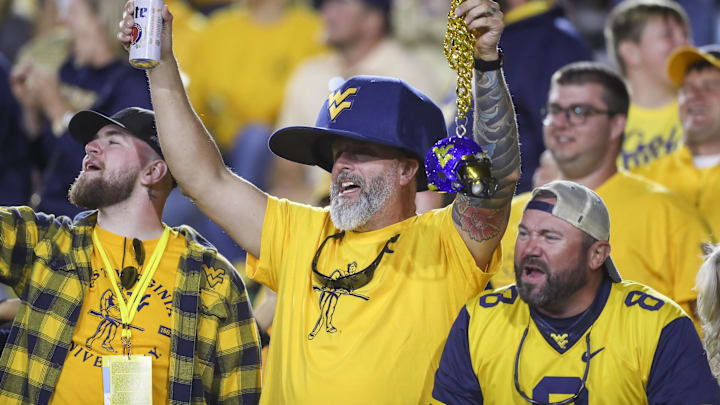 Sep 7, 2024; Morgantown, West Virginia, USA; West Virginia Mountaineers fans cheer during the third quarter against the Albany Great Danes at Mountaineer Field at Milan Puskar Stadium. Mandatory Credit: Ben Queen-Imagn Images