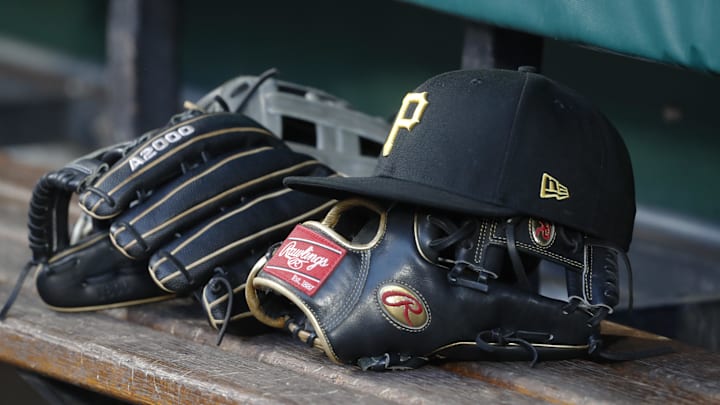 Pittsburgh Pirates hat and gloves in the dugout against the Atlanta Braves during the fourth inning at PNC Park. 