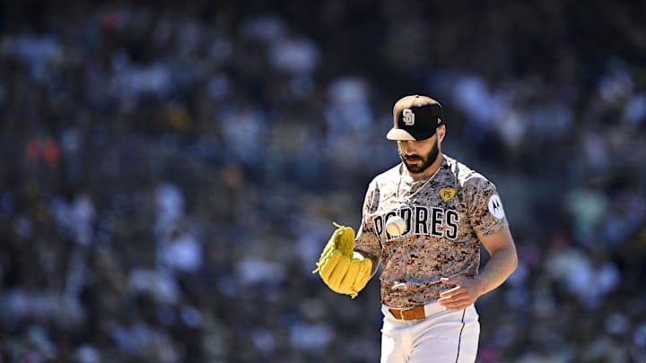 Aug 25, 2024; San Diego, California, USA; San Diego Padres relief pitcher Tanner Scott (66) tosses a ball during the eighth inning against the New York Mets at Petco Park. Mandatory Credit: Orlando Ramirez-Imagn Images