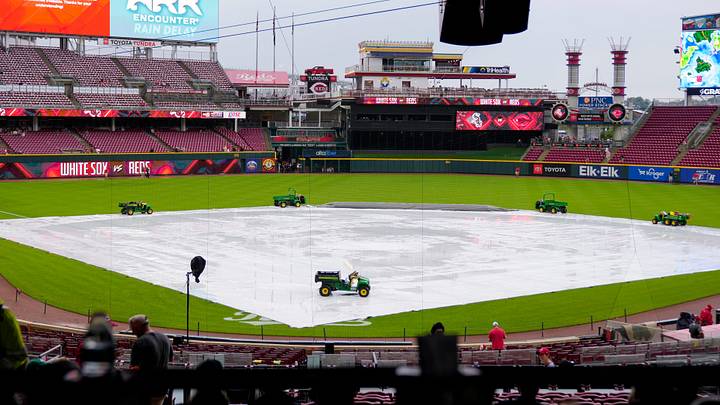 The tarp covers the infield during a rain delay before the MLB interleague game between the Cincinnati Reds and the Chicago White Sox at Great American Ball Park in Cincinnati on Tuesday, May 13, 2025. The tarp covers the infield during a rain delay before the MLB interleague game between the Cincinnati Reds and the Chicago White Sox at Great American Ball Park in Cincinnati on Tuesday, May 13, 2025.