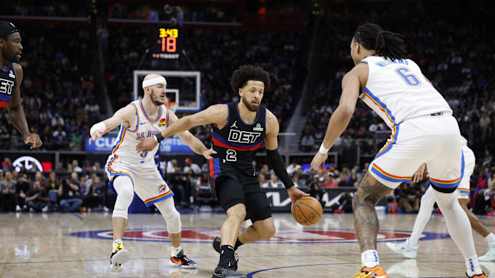 Mar 15, 2025; Detroit, Michigan, USA;  Detroit Pistons guard Cade Cunningham (2) dribbles defended by Oklahoma City Thunder forward Jaylin Williams (6) in the first half at Little Caesars Arena. Mandatory Credit: Rick Osentoski-Imagn Images