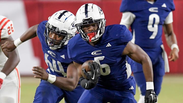 Clay-Chalkville's Taurus Chambers (5) carries the ball against Saraland High School during the AHSAA Class 6A football state championship game at Bryant Denny Stadium in Tuscaloosa, Ala., on Friday December 8, 2023.