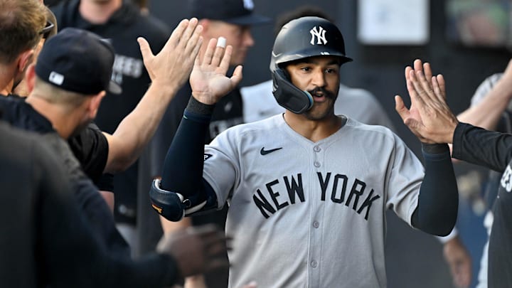 Aug 20, 2025; St. Petersburg, Florida, USA; New York Yankees center fielder Trent Grisham (12) celebrates in the dugout after hitting a solo home run in the first inning against the Tampa Bay Rays  at George M. Steinbrenner Field. Mandatory Credit: Jonathan Dyer-Imagn Images