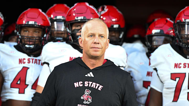 Sep 11, 2025; Winston-Salem, North Carolina, USA;  North Carolina State Wolfpack head coach Dave Doeren walks his team out on the field against the Wake Forest Demon Deacons at Allegacy Federal Credit Union Stadium. Mandatory Credit: Luke Jamroz-Imagn Images