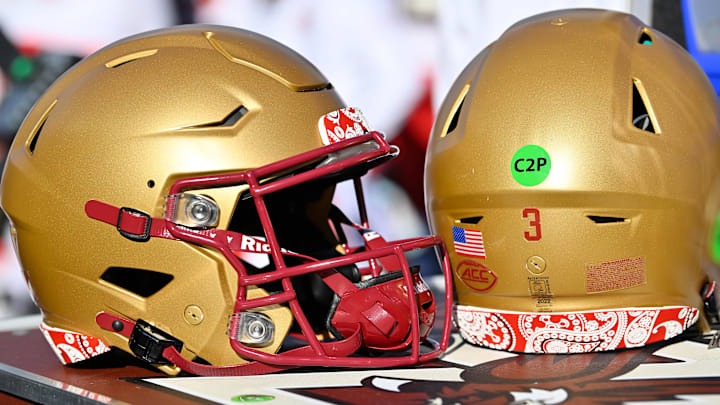 Nov 8, 2025; Chestnut Hill, Massachusetts, USA; A pair of Boston College Eagles helmets trimmed in red paisley in memory of BC alum Welles Remy Crowther are displayed on an equipment cart during the first half against the Southern Methodist University Mustangs at Alumni Stadium. Mandatory Credit: Eric Canha-Imagn Images