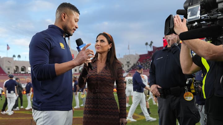 Nov 30, 2024; Los Angeles, California, USA; CBS Sports sideline reporter Jenny Dell (right) interviews Notre Dame Fighting Irish head coach Marcus Freeman after the game against the Southern California Trojans at United Airlines Field at Los Angeles Memorial Coliseum. Mandatory Credit: Kirby Lee-Imagn Images