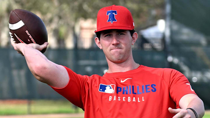 Feb 12, 2025; Clearwater, FL, USA; Philadelphia Phillies pitcher Andrew Painter (76) throws a football during a spring training workout.