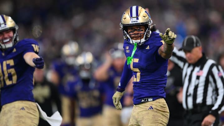 Nov 15, 2025; Seattle, Washington, USA; Washington Huskies wide receiver Omari Evans (5) celebrates after catching the ball against the Purdue Boilermakers during the first half at Husky Stadium. Mandatory Credit: Steven Bisig-Imagn Images