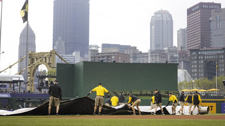 May 1, 2022; Pittsburgh, Pennsylvania, USA; The Pittsburgh Pirates ground crew rolls out the field tarp before the start of the game against the San Diego Padres at PNC Park. Rain forced an 80 minute delay to the start of the game. Mandatory Credit: Scott Galvin-Imagn Images