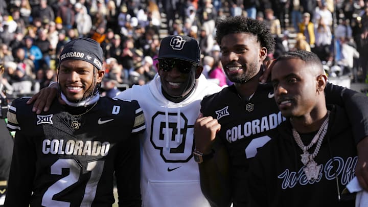 Nov 29, 2024; Boulder, Colorado, USA; Colorado Buffaloes safety Shilo Sanders (21) and head coach Deion Sanders and quarterback Shedeur Sanders (2) and social media producer Deion Sanders Jr. following the win against the Oklahoma State Cowboys at Folsom Field. 