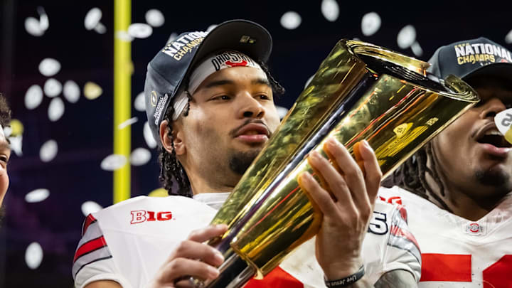 Ohio State Buckeyes wide receiver Emeka Egbuka (2) celebrates with the championship trophy. Ohio State Buckeyes wide receiver Emeka Egbuka (2) celebrates with the championship trophy.