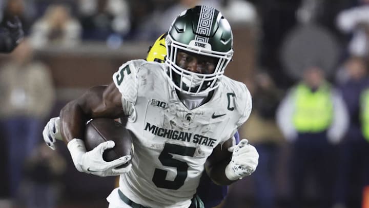 Oct 26, 2024; Ann Arbor, Michigan, USA;  Michigan State Spartans running back Nate Carter (5) rushes against the Michigan Wolverines at Michigan Stadium. Mandatory Credit: Rick Osentoski-Imagn Images