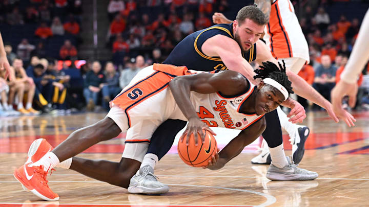Feb 11, 2026; Syracuse, New York, USA; Syracuse Orange forward William Kyle III (42) gets control of a loose ball in front of California Golden Bears center Milos Ilic (8) in the first half at the JMA Wireless Dome. Mandatory Credit: Mark Konezny-Imagn Images
