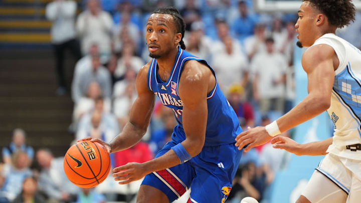 Nov 7, 2025; Chapel Hill, North Carolina, USA; Kansas Jayhawks guard Darryn Peterson (22) dribbles as North Carolina Tar Heels guard Seth Trimble (7) defends in the first half at Dean E. Smith Center. Mandatory Credit: Bob Donnan-Imagn Images
