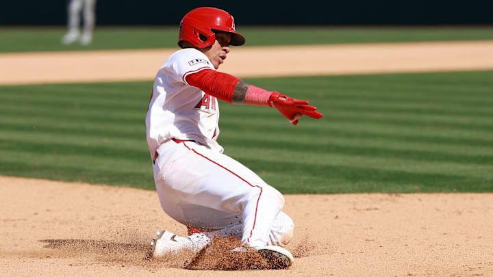 Apr 24, 2024; Anaheim, California, USA; Los Angeles Angels shortstop Ehire Adrianza (13) slides to the third base on a throwing error during the ninth inning against the Baltimore Orioles at Angel Stadium. Mandatory Credit: Kiyoshi Mio-Imagn Images Apr 24, 2024; Anaheim, California, USA; Los Angeles Angels shortstop Ehire Adrianza (13) slides to the third base on a throwing error during the ninth inning against the Baltimore Orioles at Angel Stadium. Mandatory Credit: Kiyoshi Mio-Imagn Images