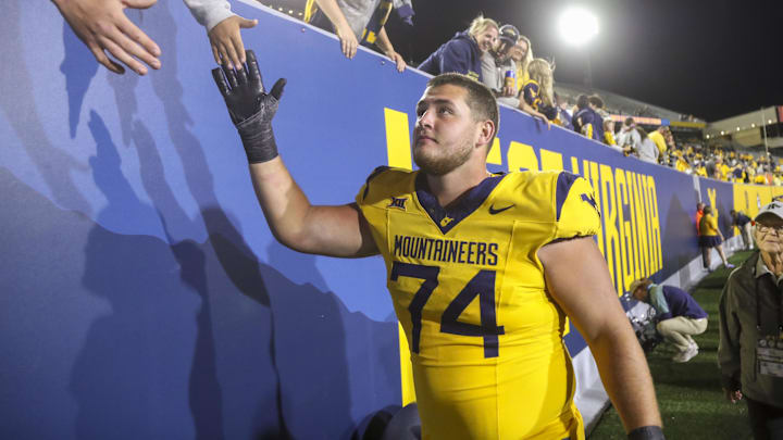 Sep 7, 2024; Morgantown, West Virginia, USA; West Virginia Mountaineers offensive lineman Wyatt Milum (74) celebrates with fans after defeating the Albany Great Danes at Mountaineer Field at Milan Puskar Stadium. Mandatory Credit: Ben Queen-Imagn Images