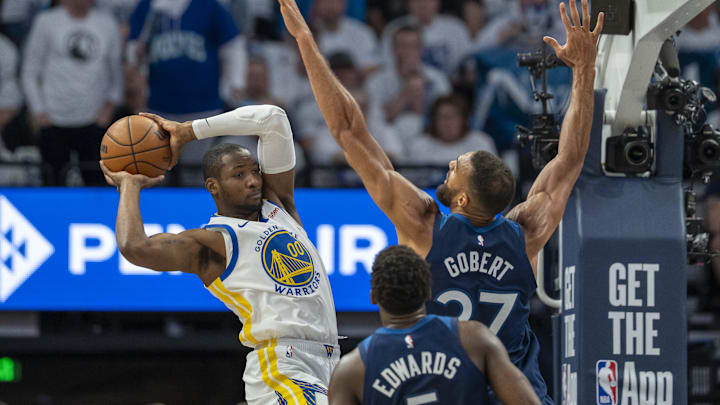 May 8, 2025; Minneapolis, Minnesota, USA; Golden State Warriors forward Jonathan Kuminga (00) looks to pass the ball over Minnesota Timberwolves center Rudy Gobert (27) in the first half during game two of the second round for the 2025 NBA Playoffs at Target Center. Mandatory Credit: Jesse Johnson-Imagn Images