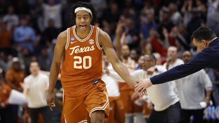 Mar 19, 2025; Dayton, OH, USA; Texas Longhorns guard Tre Johnson (20) high fives Xavier Musketeers head coach Sean Miller after making a three point basket in the second half at UD Arena. Mandatory Credit: Rick Osentoski-Imagn Images