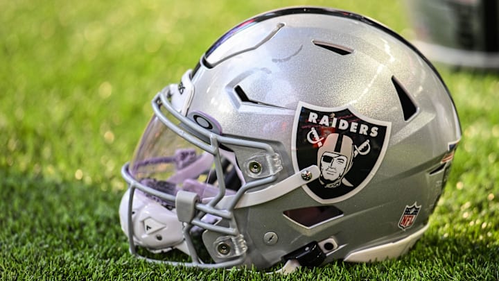 A Las Vegas Raiders helmet sits on the field before the game against the Minnesota Vikings at U.S. Bank Stadium.