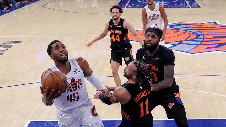 May 21, 2026; New York, New York, USA; Cleveland Cavaliers guard Donovan Mitchell (45) drives to the basket against New York Knicks guard Jalen Brunson (11) and center Mitchell Robinson (23) and guard Landry Shamet (44) during the third quarter of game two of the eastern conference finals during the 2026 NBA playoffs at Madison Square Garden. Mandatory Credit: Brad Penner-Imagn Images