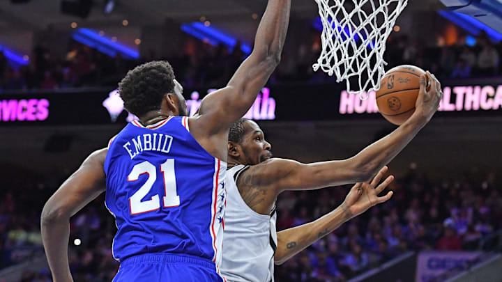 Mar 10, 2022; Philadelphia, Pennsylvania, USA; Brooklyn Nets forward Kevin Durant (7) drives to the basket against Philadelphia 76ers center Joel Embiid (21) during the second quarter at Wells Fargo Center. Mandatory Credit: Eric Hartline-Imagn Images