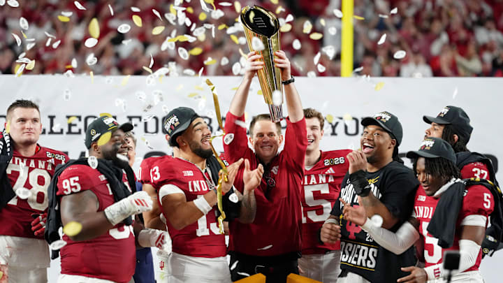 Jan 19, 2026; Miami Gardens, FL, USA; Indiana Hoosiers head coach Curt Cignetti holds up the trophy as the team celebrates winning the College Football Playoff National Championship game at Hard Rock Stadium. 