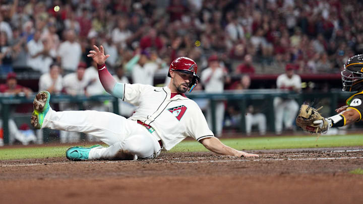 Sep 29, 2024; Phoenix, Arizona, USA; Arizona Diamondbacks outfielder Randal Grichuk (15) beats the tag of San Diego Padres catcher Kyle Higashioka (20) to score a run during the fourth inning at Chase Field.