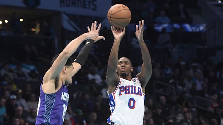 Dec 3, 2024; Charlotte, North Carolina, USA;  Philadelphia 76ers guard Tyrese Maxey (0) shoots past the defense of Charlotte Hornets guard Josh Green (10) during the first half at the Spectrum Center. Mandatory Credit: Sam Sharpe-Imagn Images
