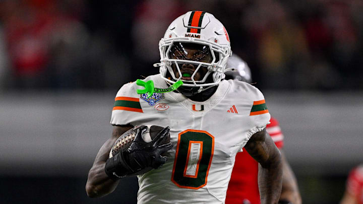 Dec 31, 2025; Arlington, TX, USA; Miami Hurricanes defensive back Keionte Scott (0) returns an interception for a touchdown during the 2025 Cotton Bowl and quarterfinal game of the College Football Playoff at AT&T Stadium. Mandatory Credit: Jerome Miron-Imagn Images