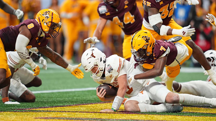 Texas Longhorns quarterback Quinn Ewers (3) recovers a fumble in the end zone while being tackled by Arizona State Sun Devils defensive back Shamari Simmons (7) for a safety during the second half of the Peach Bowl at Mercedes-Benz Stadium. Texas Longhorns quarterback Quinn Ewers (3) recovers a fumble in the end zone while being tackled by Arizona State Sun Devils defensive back Shamari Simmons (7) for a safety during the second half of the Peach Bowl at Mercedes-Benz Stadium.