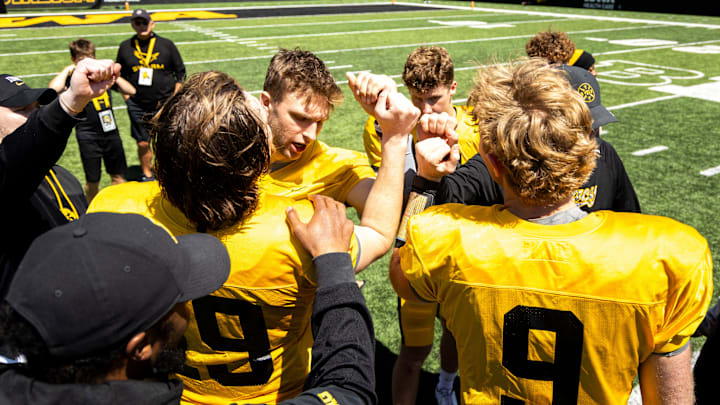 Apr 26, 2025; Iowa City, IA, USA; Iowa quarterbacks (clockwise from left) Jackson Stratton, (19) Mark Gronowski, Jimmy Sullivan and Hank Brown huddle up together after a spring NCAA football open practice at Kinnick Stadium. Mandatory Credit: Joseph Cress-The Des Moines Register