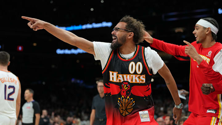 Trae Young and the Hawks' bench react during against the Phoenix Suns. Trae Young and the Hawks' bench react during against the Phoenix Suns.