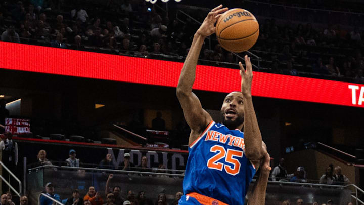 Dec 15, 2024; Orlando, Florida, USA; New York Knicks guard Mikal Bridges (25) lays the ball in over Orlando Magic guard Anthony Black (0) in the first quarter at Kia Center. Mandatory Credit: Jeremy Reper-Imagn Images