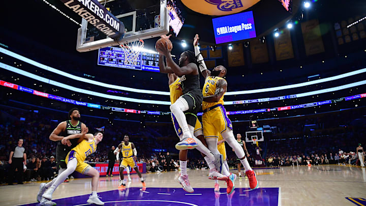 Apr 11, 2023; Los Angeles, California, USA; Minnesota Timberwolves forward Taurean Prince (12) moves to the basket against Los Angeles Lakers forward LeBron James (6) during the second half at Crypto.com Arena. Mandatory Credit: Gary A. Vasquez-USA TODAY Sports Apr 11, 2023; Los Angeles, California, USA; Minnesota Timberwolves forward Taurean Prince (12) moves to the basket against Los Angeles Lakers forward LeBron James (6) during the second half at Crypto.com Arena. Mandatory Credit: Gary A. Vasquez-USA TODAY Sports