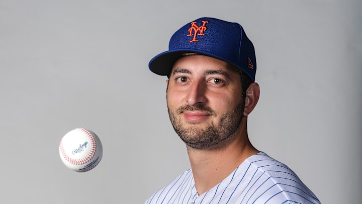 Thomas Szapucki poses with a baseball in air at New York Mets Photo Day