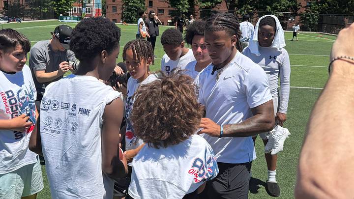 New England Patriots wide receiver DeMario Douglas signing autographs at his youth skills camp in Boston. New England Patriots wide receiver DeMario Douglas signing autographs at his youth skills camp in Boston.