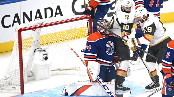 May 14, 2023; Edmonton, Alberta, CAN; Edmonton Oilers goalie Stuart Skinner (74) battes with Vegas Golden Knights centre   Nicolas Roy (10) and right winger Reilly Smith (19) in the first period in game six of the second round of the 2023 Stanley Cup Playoffs at Rogers Place. Mandatory Credit: Walter Tychnowicz-Imagn Images