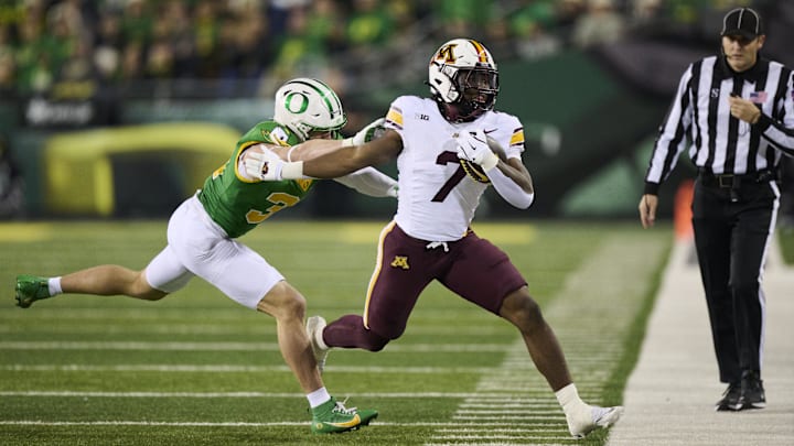 Nov 14, 2025; Eugene, Oregon, USA; Minnesota Golden Gophers running back Fame Ijeboi (7) is forced out of bounds during the first half against Oregon Ducks defensive back Dillon Thieneman (31) at Autzen Stadium. Mandatory Credit: Troy Wayrynen-Imagn Images