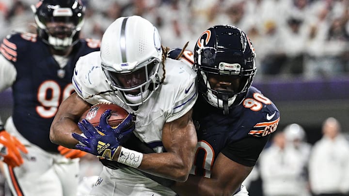 Dec 16, 2024; Minneapolis, Minnesota, USA; Minnesota Vikings running back Aaron Jones (33) is tackled by Chicago Bears defensive end Dominique Robinson (90) during the third quarter at U.S. Bank Stadium. Mandatory Credit: Jeffrey Becker-Imagn Images