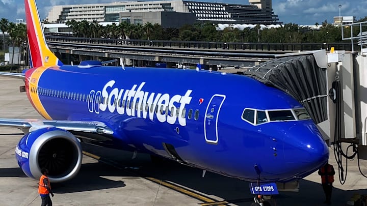 A Southwest Airlines plane prepares to depart from a gate at...